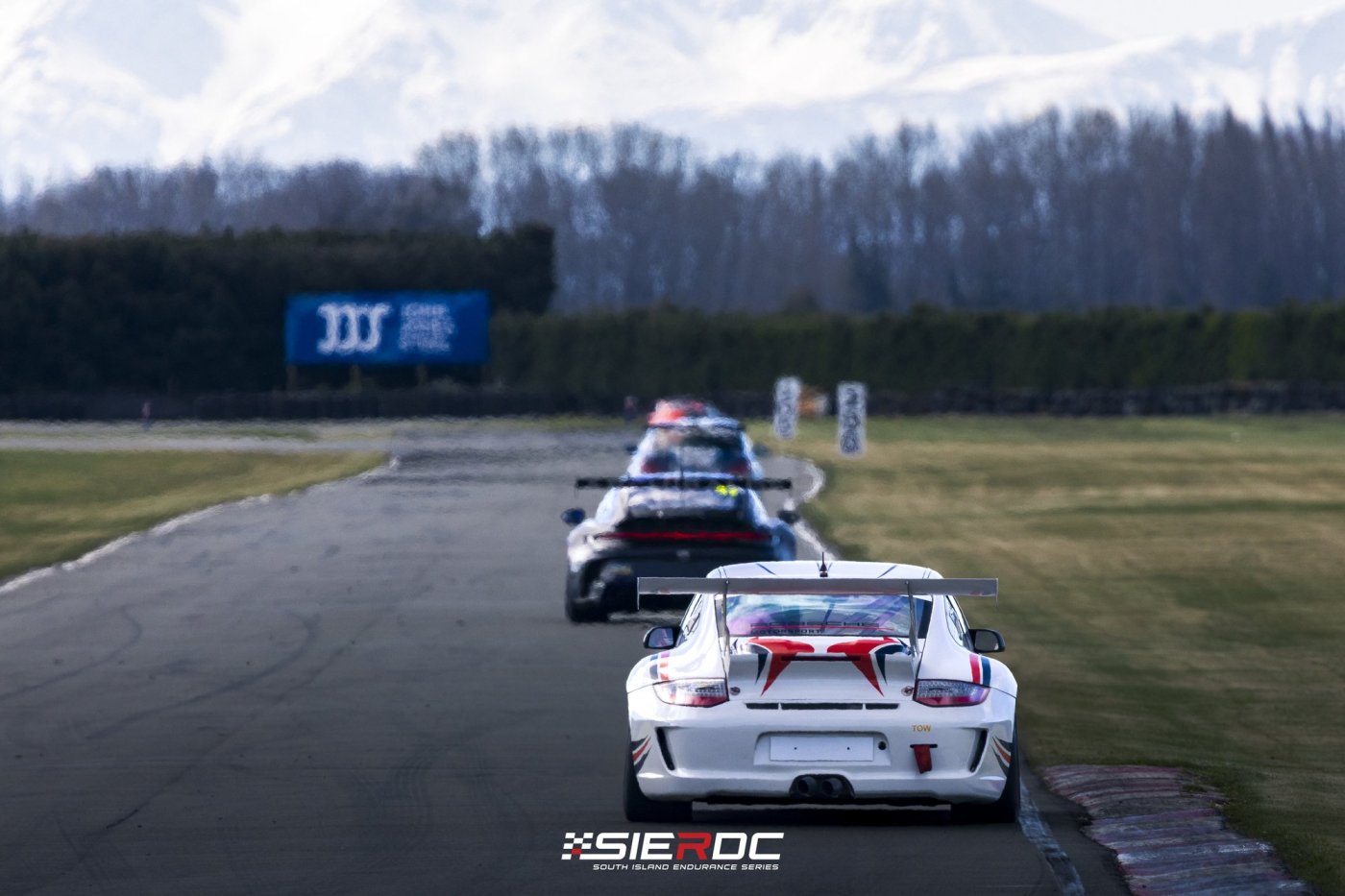 Porsche Cup cars running line astern with the Southern Alps behind