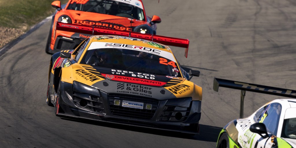Yellow Audi R8 #24 leading the orange Redbridge Porsche #148 at Levels