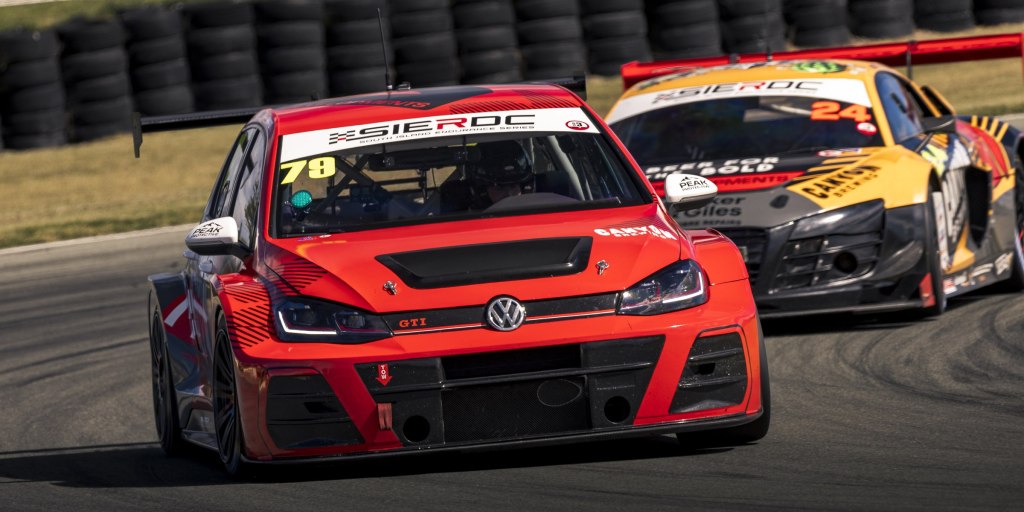 Red VW Golf GTI #79 leading the Audi R8 #24 at Levels