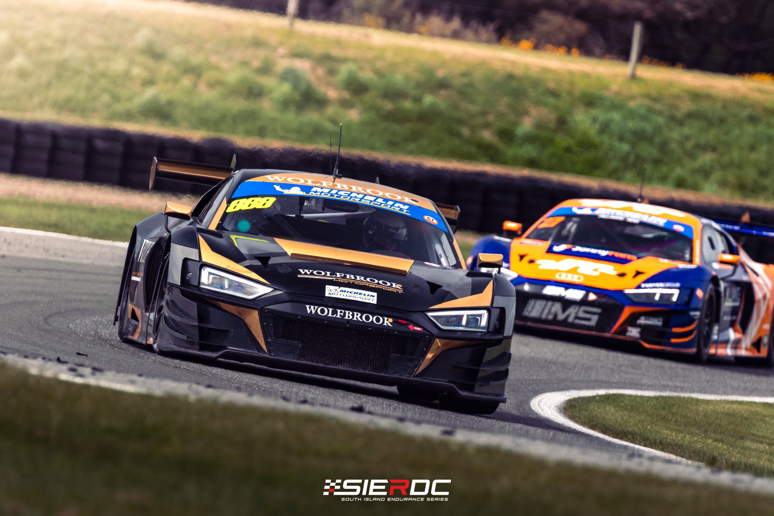 Steve Brooks and Willie Exton's black-and-gold Audi R8 #888 leading the IMS Audi of Sam Fillmore and Jonny Reid at Teretonga